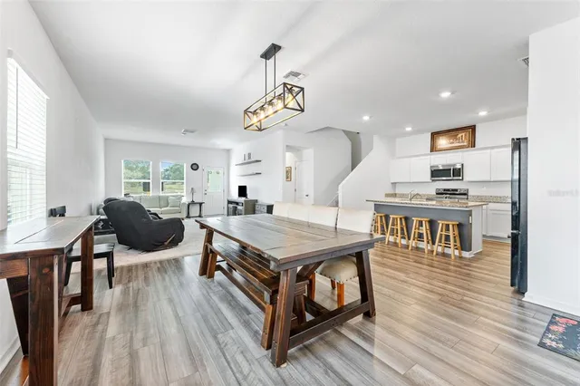 a living room with furniture a wooden floor and window