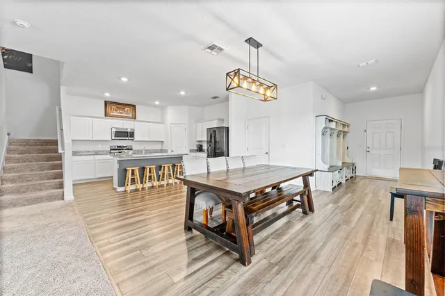 an open kitchen with a table and chairs in it