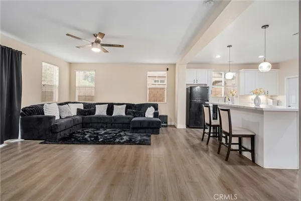 a living room with furniture and kitchen view