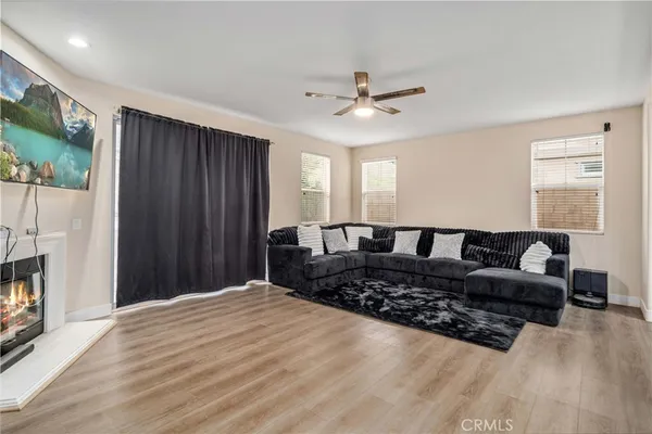 a large bed sitting in a spacious bedroom next to a window