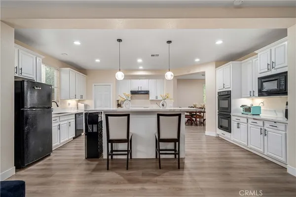 a large kitchen with a table and chairs