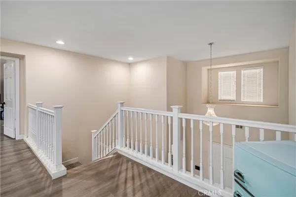 a view of hallway with stairs and wooden floor