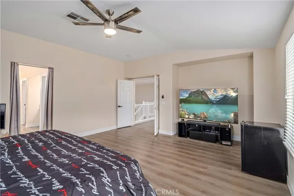 a bedroom with a bed and a large window