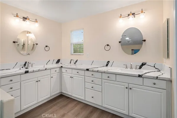 a bathroom with a double vanity sink and a mirror