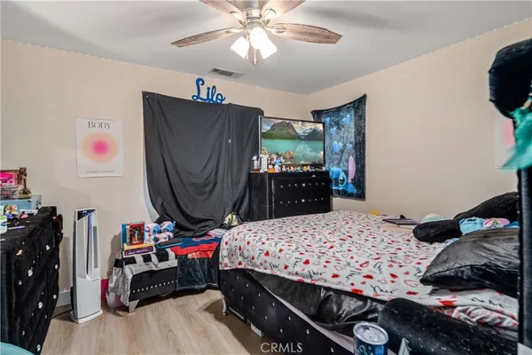 a bedroom with a bed and a dresser in it