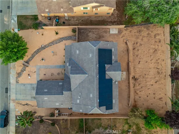 an aerial view of a house with yard