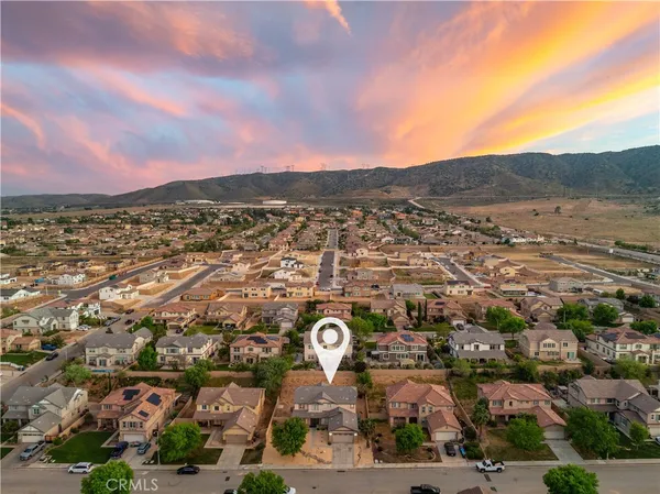 an aerial view of residential houses with outdoor space and street view