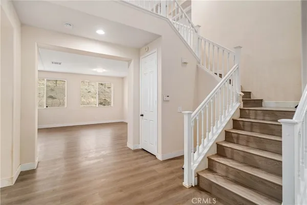 a view of entryway with wooden floor and stairs