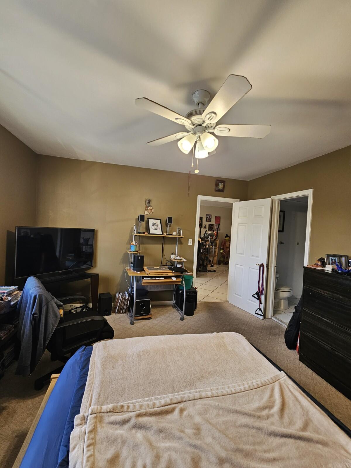 119 Northeast 19th Court, Unit 211G Wilton Manors, FL 33305 - Photo 11 of 21 a bedroom with a bed and a flat tv screen on dresser