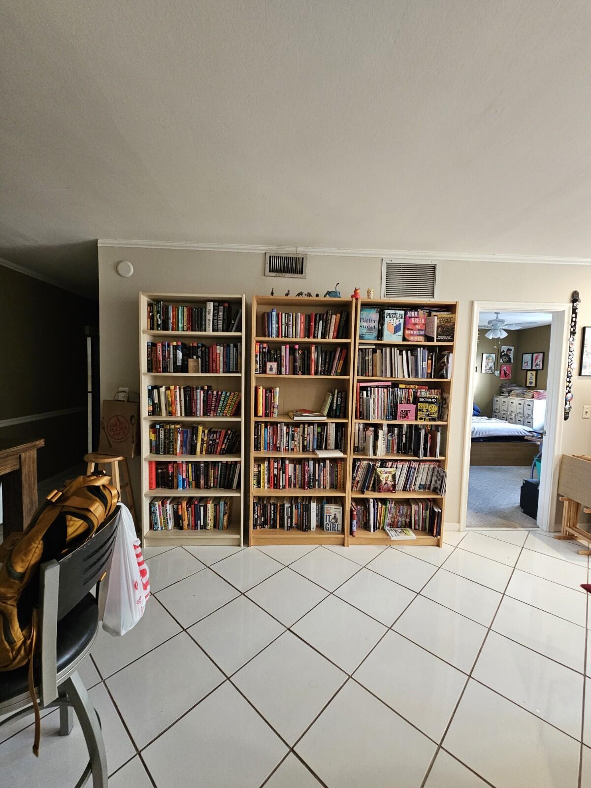 119 Northeast 19th Court, Unit 211G Wilton Manors, FL 33305 - Photo 4 of 21 a room with furniture and book shelf