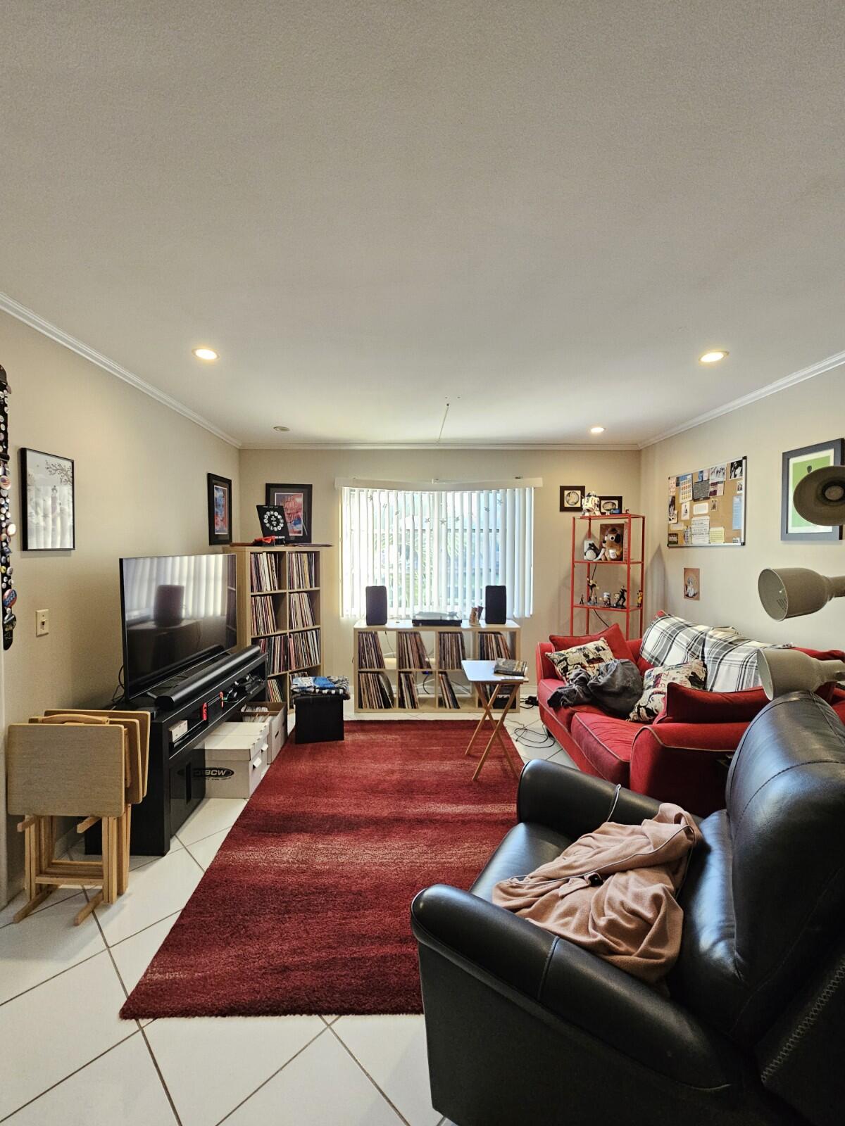 119 Northeast 19th Court, Unit 211G Wilton Manors, FL 33305 - Photo 5 of 21 a living room with furniture and a flat screen tv