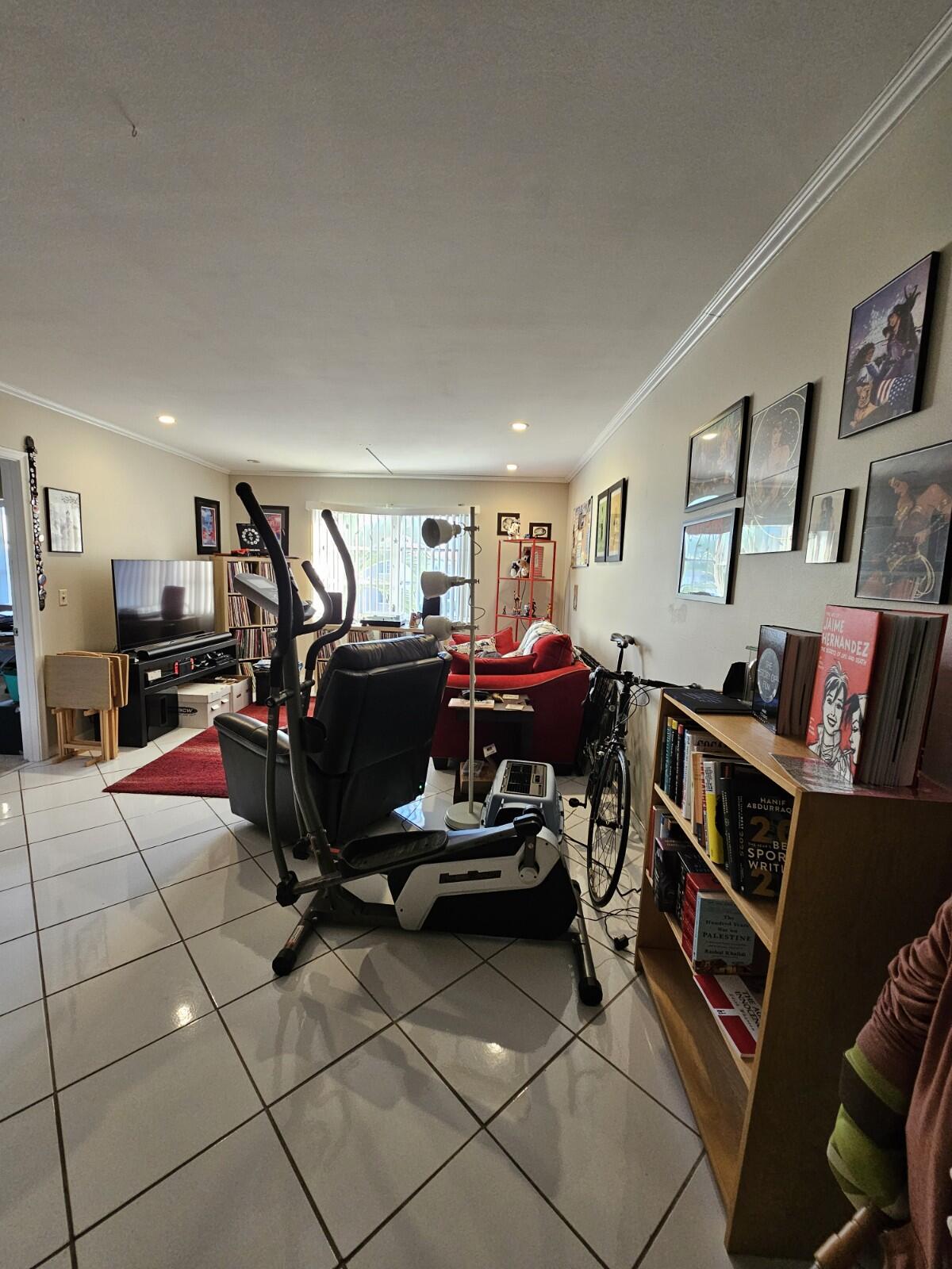 119 Northeast 19th Court, Unit 211G Wilton Manors, FL 33305 - Photo 7 of 21 a living room with furniture a air conditioner and a window