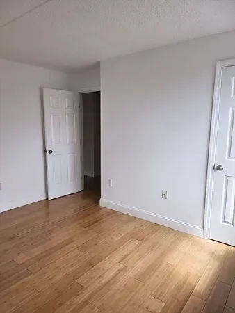 a view of an empty room and wooden floor