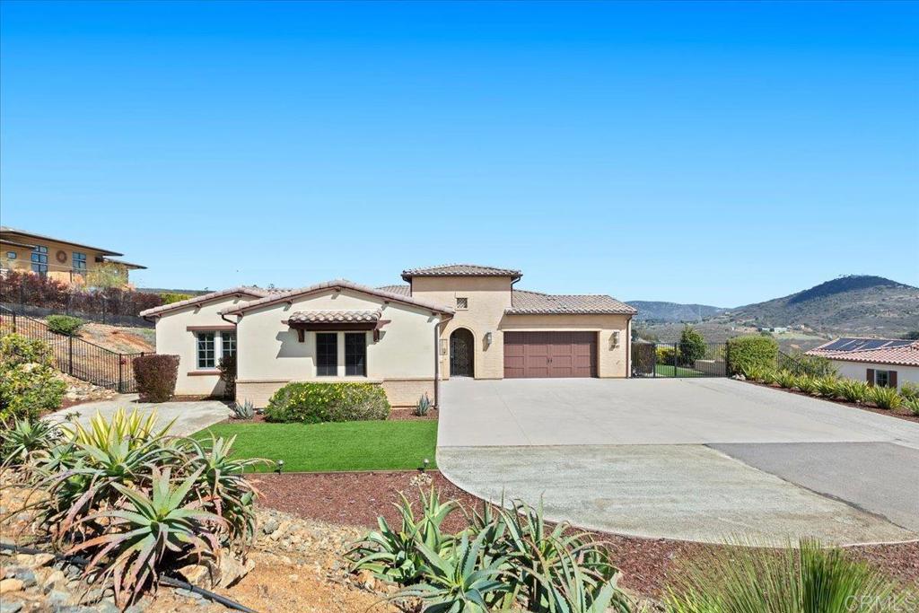 3849 Rancho Summit Drive Encinitas, CA 92024 - Photo 15 of 63 a front view of a house with a yard and garage