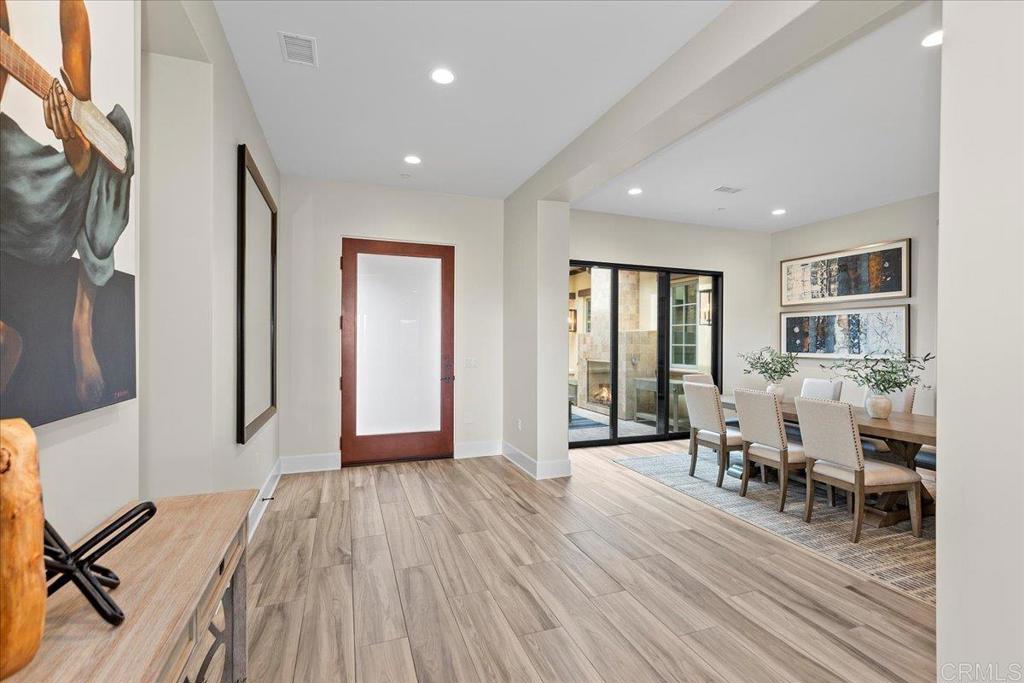 3849 Rancho Summit Drive Encinitas, CA 92024 - Photo 20 of 63 a furnished dining room with stairs and furniture