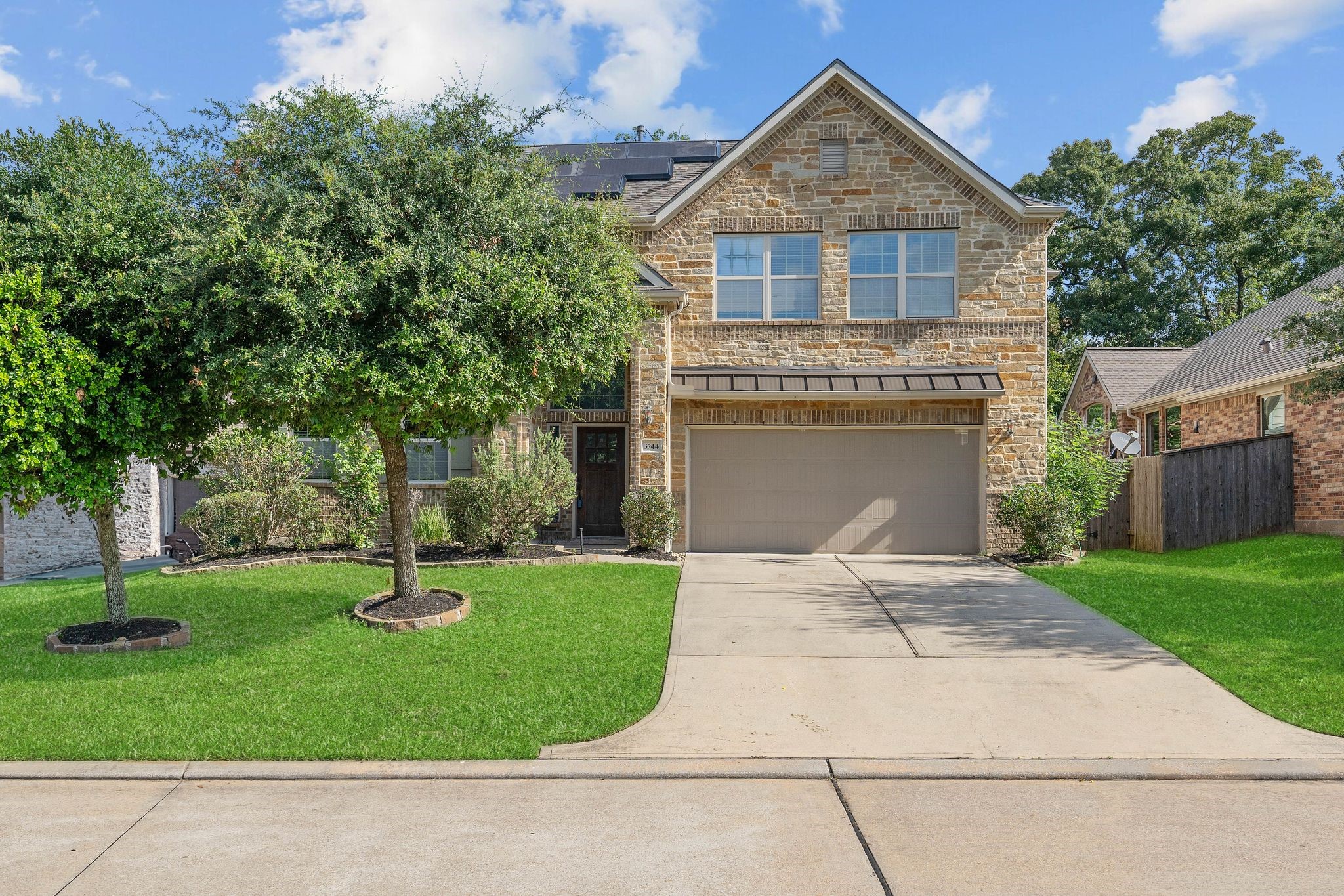 3544 Woods Estates Drive Conroe, TX 77304 - Photo 1 of 46 a front view of a house with a yard