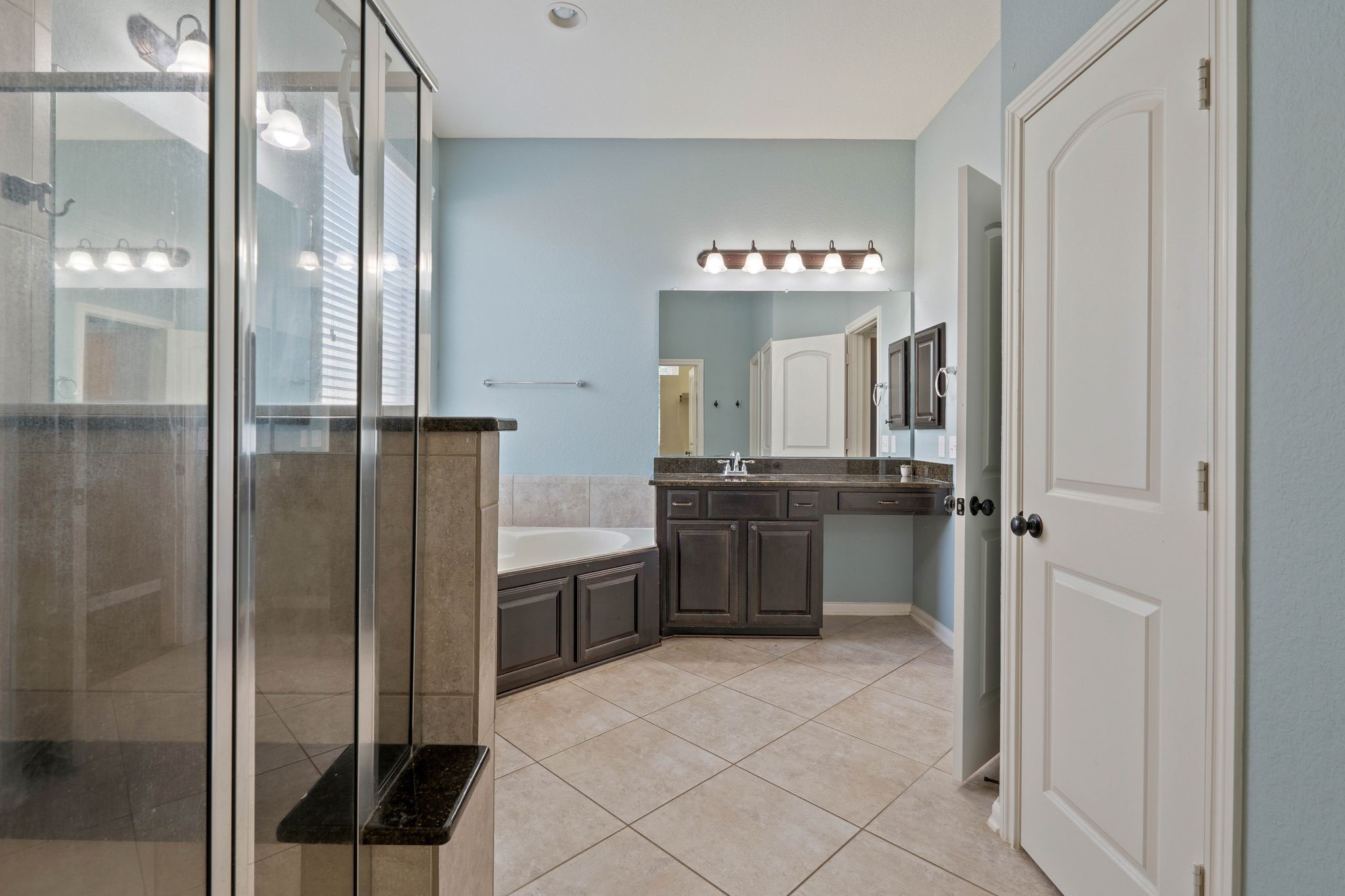 3544 Woods Estates Drive Conroe, TX 77304 - Photo 22 of 46 a bathroom with a mirror and a shower