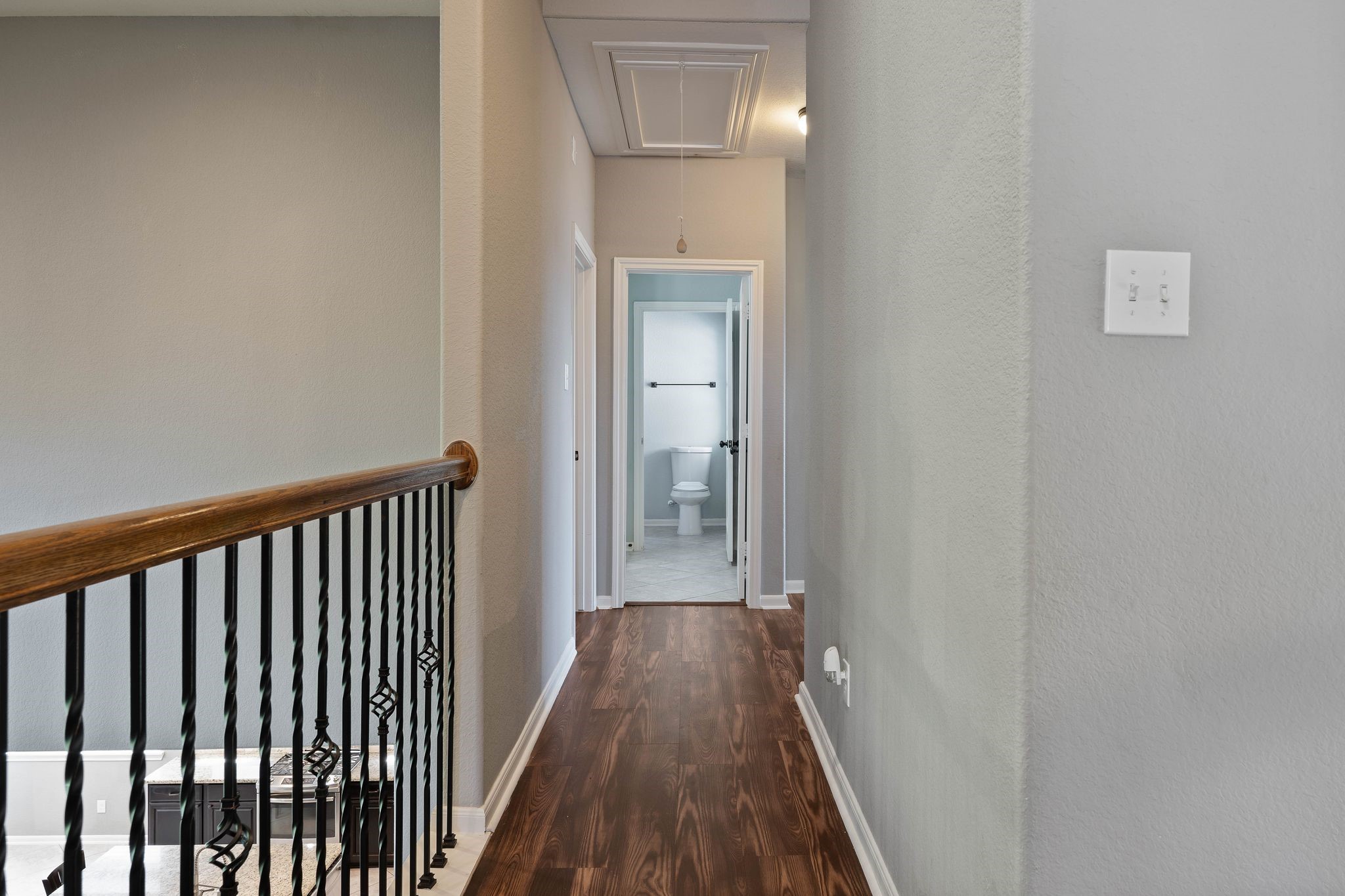 3544 Woods Estates Drive Conroe, TX 77304 - Photo 23 of 46 a view of a hallway with wooden floor and a bathroom