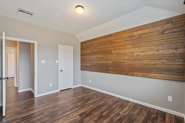 a view of an empty room and wooden floor