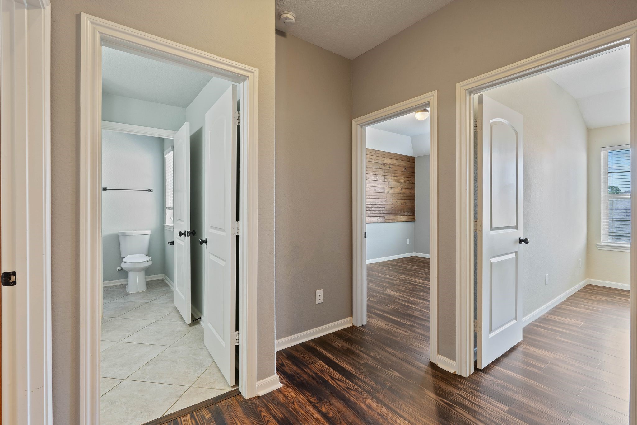 3544 Woods Estates Drive Conroe, TX 77304 - Photo 30 of 46 a view of a bathroom from a hallway with wooden floor