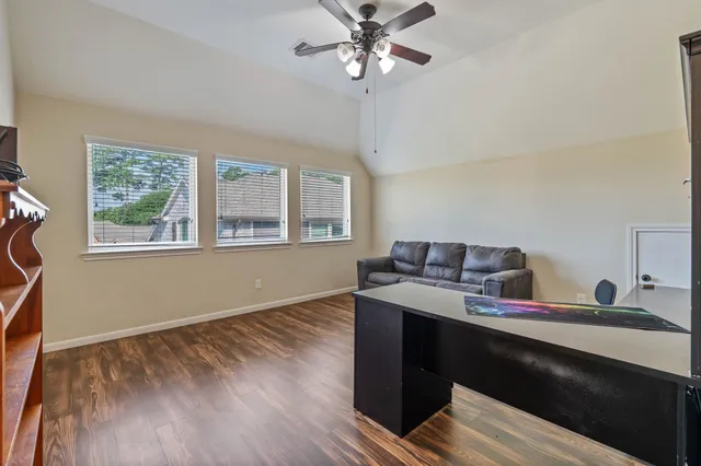 a view of a workspace with furniture and a window