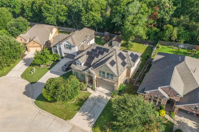 an aerial view of a house with garden space and street view