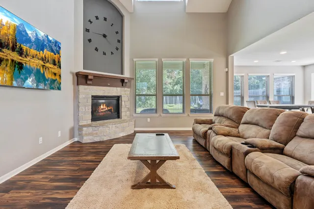a living room with furniture a rug and a fireplace