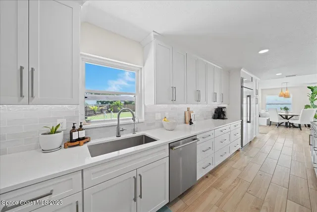 a kitchen with granite countertop a stove and a sink