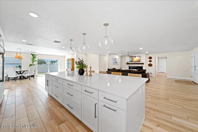 a kitchen with white cabinets appliances and center island