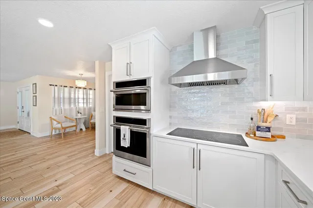 a dining room with furniture wooden floor and a potted plant