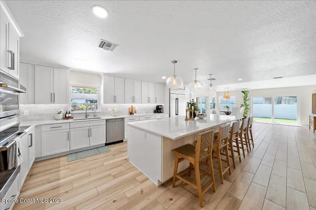 a bathroom with a toilet a sink a mirror and a shower