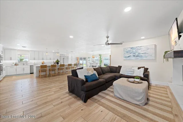 a view of a kitchen with fridge and wooden floor