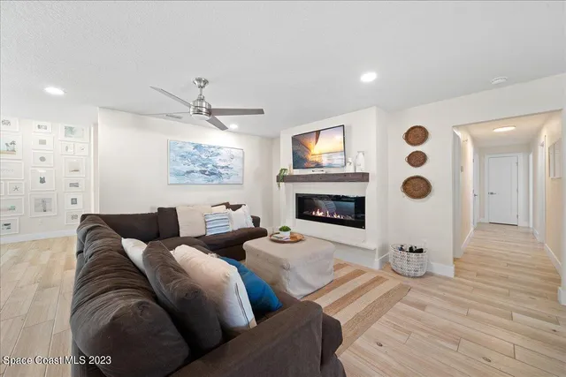 a spacious bedroom with a bed a couch and potted plant