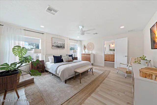a bathroom with a double vanity sink a mirror a bathtub and shower