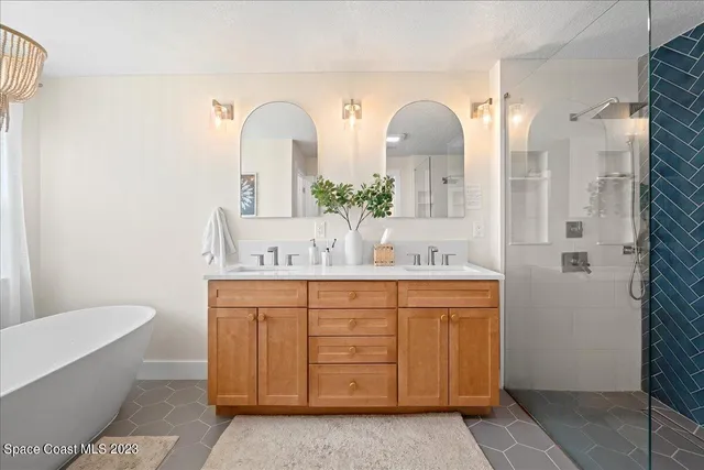 a bathroom with a bathtub a sink and a mirror