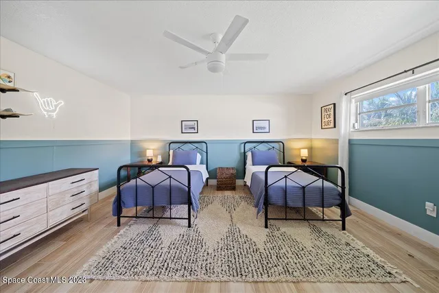 a bedroom with a bed and a large mirror