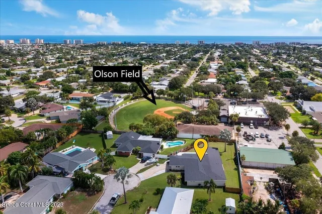 an aerial view of residential houses with outdoor space