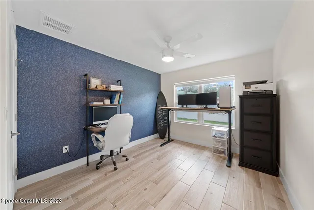 a swimming pool with outdoor seating and yard in the back