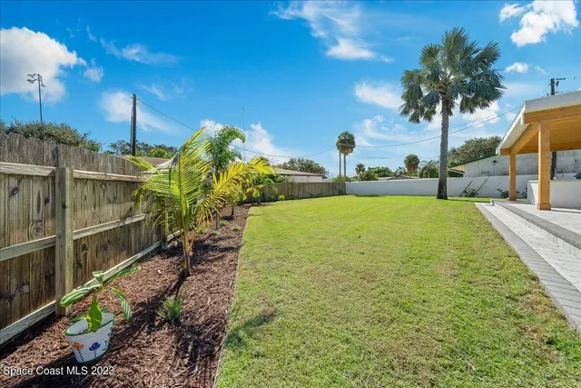 a view of a patio with a table and chairs