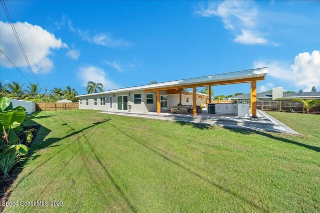 a kitchen with a sink cabinets and wooden floor