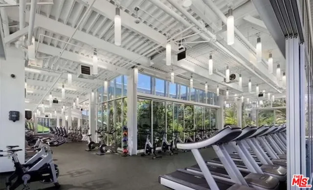 a view of gym with large windows