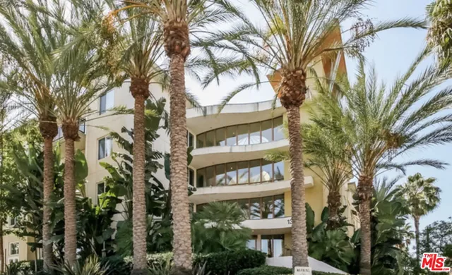 a view of a street sign and trees