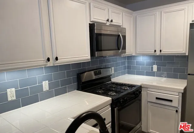 a kitchen with a stove and a microwave