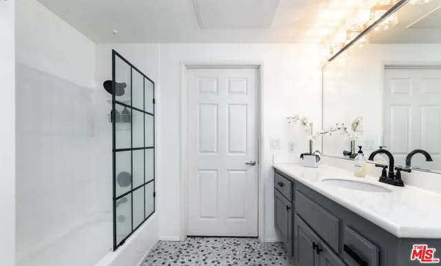 a bathroom with a sink and a mirror