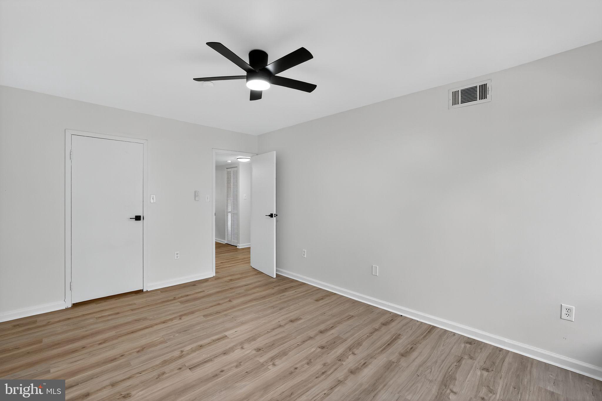 8481 Greenbelt Road, Unit 201 Greenbelt, MD 20770 - Photo 21 of 26 a view of a big room with wooden floor and windows