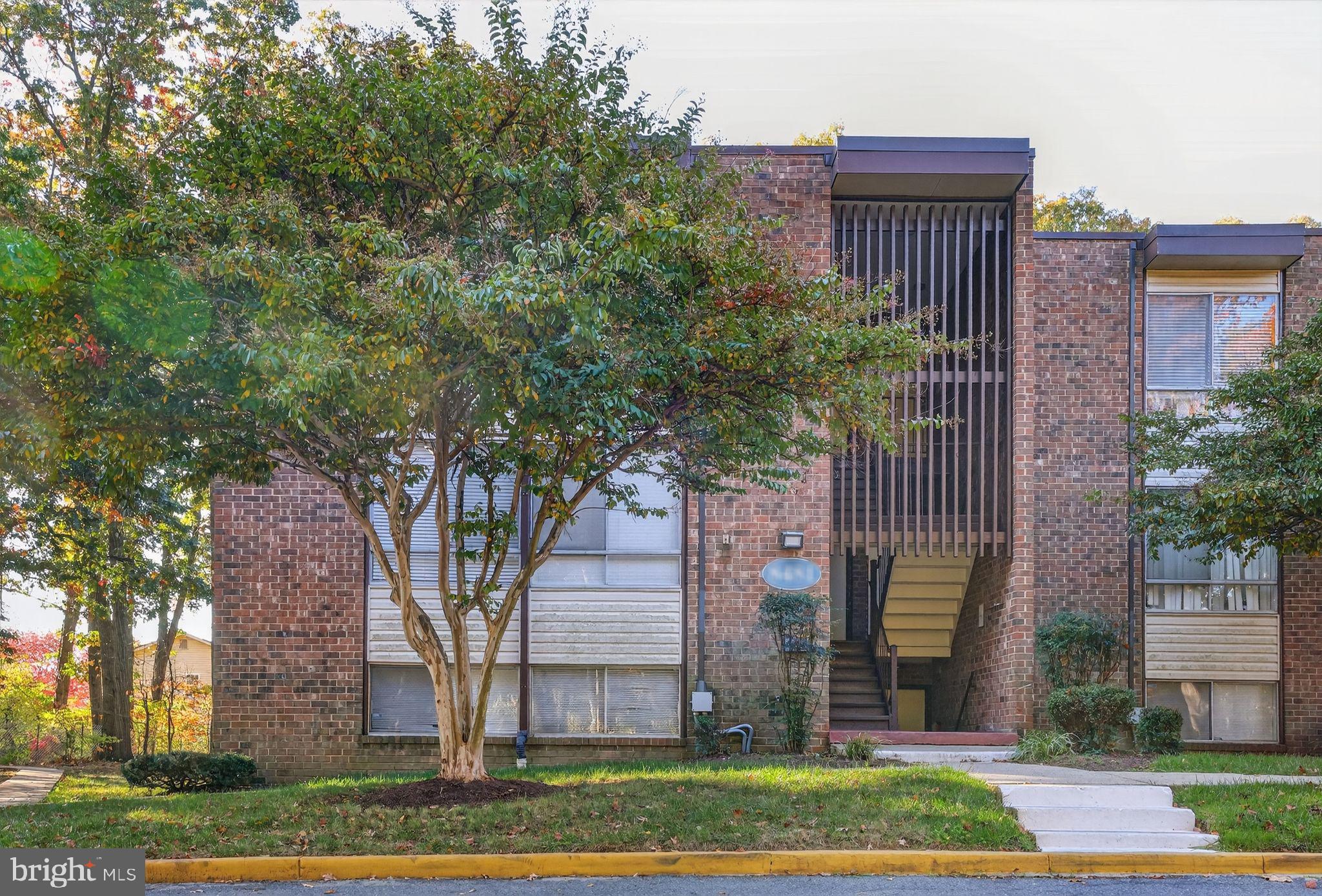 8481 Greenbelt Road, Unit 201 Greenbelt, MD 20770 - Photo 26 of 26 a front view of a house with garden