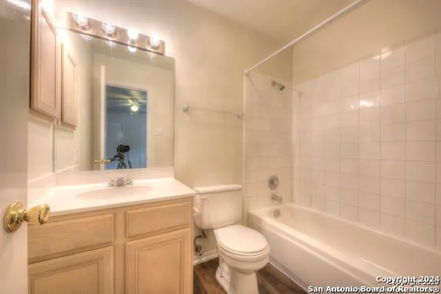 a bathroom with a sink a toilet a large mirror and shower