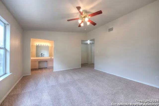 a view of a backyard with wooden fence