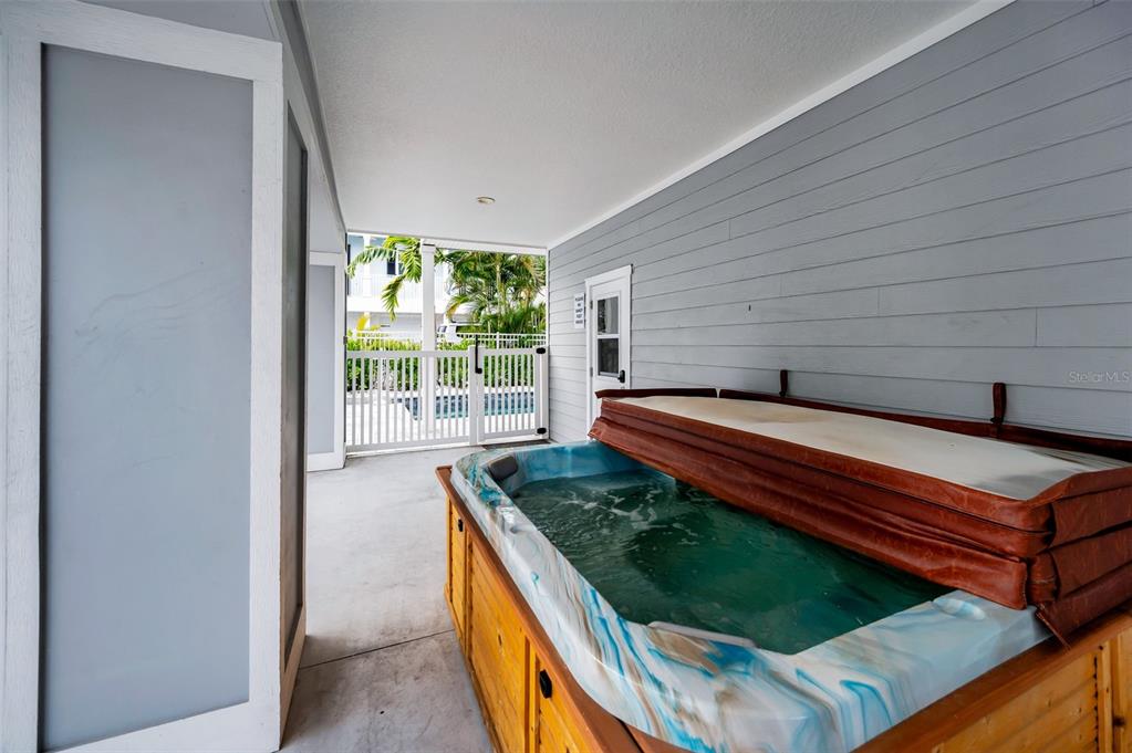 204 Gulf Boulevard Indian Rocks Beach, FL 33785 - Photo 11 of 72 a backyard of a house with a garden and outdoor seating