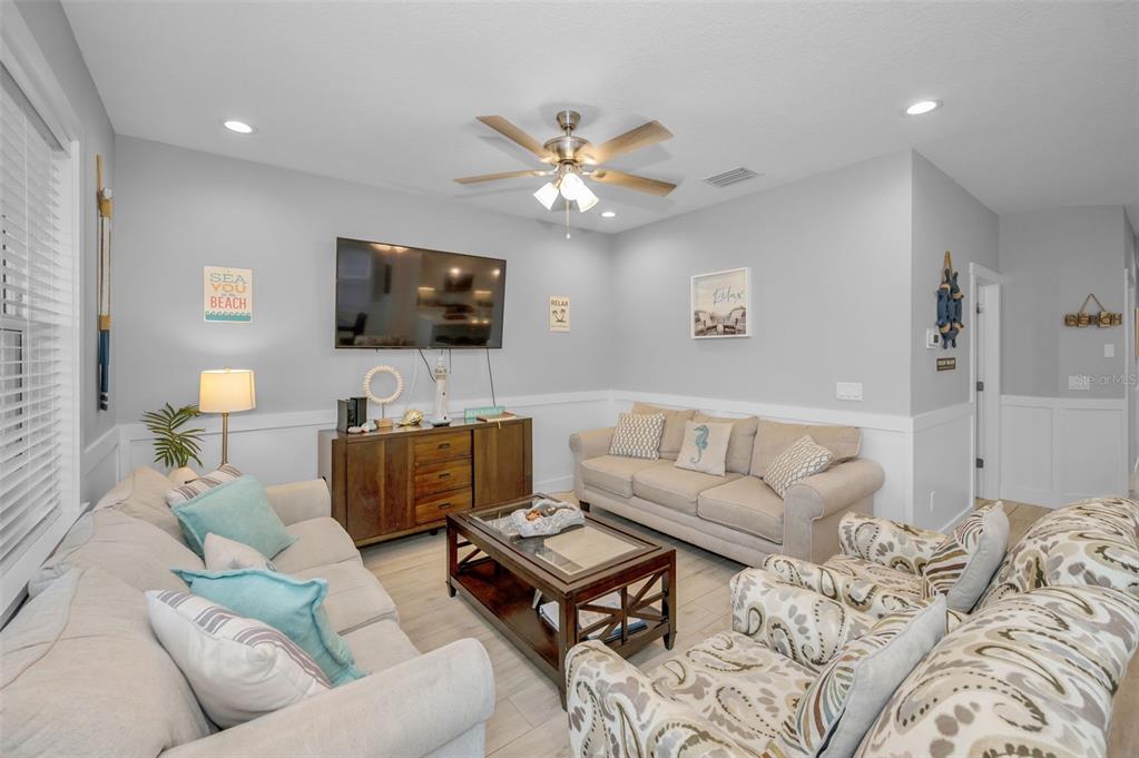 204 Gulf Boulevard Indian Rocks Beach, FL 33785 - Photo 17 of 72 a living room with furniture and a flat screen tv